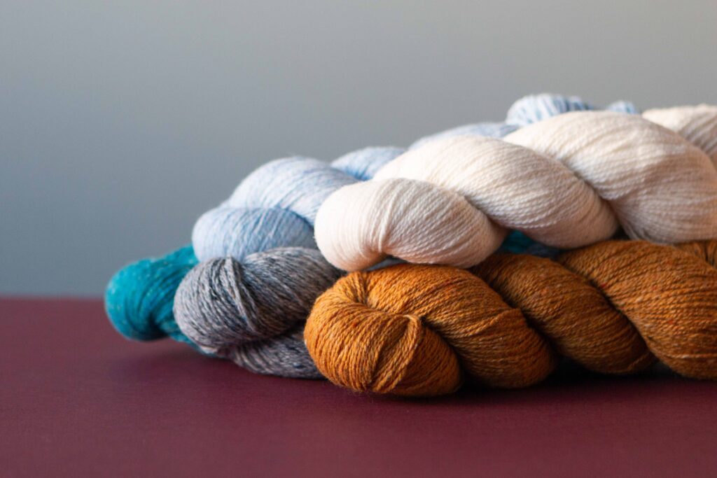 a plump and bouncy yarn shot of 5 skeins of Darnie by Stolen Stitches